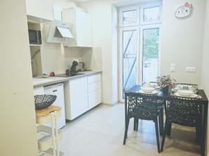 a kitchen with a table and chairs and a window at Chez Alice 2 in Montbéliard