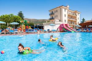 a group of children playing in a swimming pool at Camping Baciccia in Ceriale