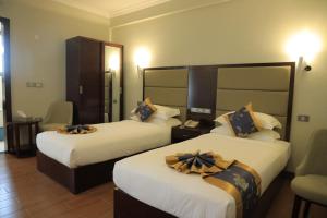 a hotel room with two beds with bows on them at Nile View Hotels in Bahir Dar