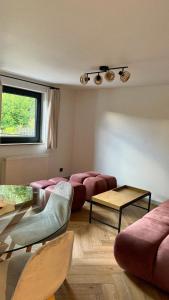 a living room with couches and tables and a window at Hi Wisła in Wisła