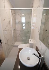 a bathroom with a white sink and a shower at Patrimonial Hotel Boutique in Cochabamba +86 photos