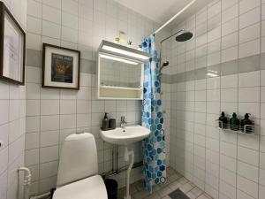 a bathroom with a toilet and a sink at Prinshöjden Apartments - Katrineholm Central in Katrineholm +20 photos