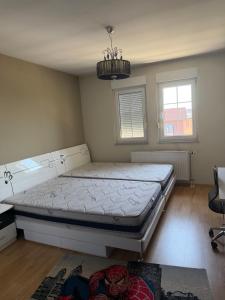 a bedroom with a bed and a chandelier at Prishtina Luxury House in Laplje Selo