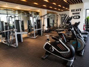 a gym with several treadmills and exercise bikes at Sky View Condo at Solaris in Christiansborg