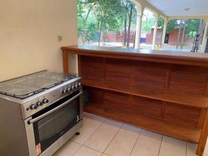 a kitchen with a stove and a counter at Samba immo chez Mbaye in Fatick