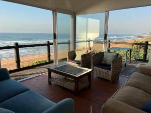 a living room with a view of the ocean at 8 Hewitt @ Tiffany's in Sheffield Beach