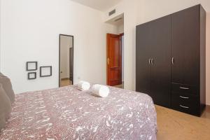 a bedroom with a bed and a black dresser at Alcalá del rio! 2 a in Alcalá del Río