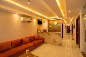 a living room with a brown couch in a room at HOTEL ICONIC At Delhi International Airport in New Delhi +32 photos