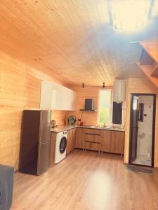 a kitchen with a refrigerator and a stove at Pine House Borjomi , Mountain View in Borjomi