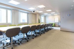 a conference room with a long table and chairs at Scandic Tampere Hämeenpuisto in Tampere