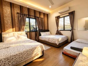 a bedroom with two beds and two windows at MELAKA BEACH VILLA ( A TYPE ) in Kelebang Besar +83 photos