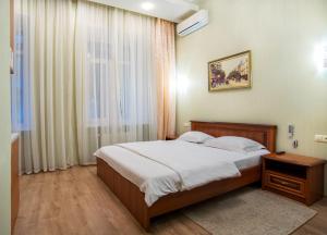 a bedroom with a large bed and a window at Soprano Apart Hotel in Odesa