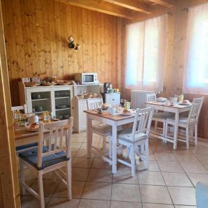 a room with two tables and chairs and a kitchen at Locanda Livenza camere in Motta di Livenza +22 photos