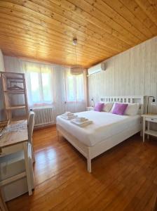 a bedroom with a large bed and a wooden ceiling at Locanda Livenza camere in Motta di Livenza