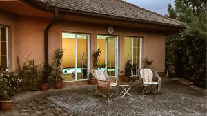 two chairs and a table in front of a house at Hide Away in a Private Countryside Villa in Prestranek