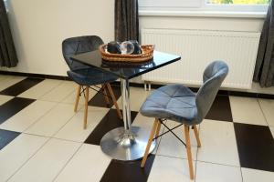 a table with two chairs and a basket on it at Panorama Motel -Wellness in Veľký Meder