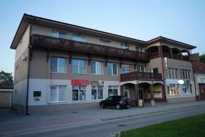 a building with a car parked in front of it at Panorama Motel -Wellness in Veľký Meder