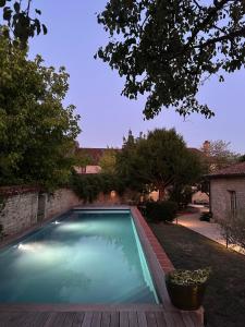 a swimming pool in the yard of a house at La Maison du 19 in Cluny
