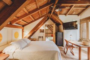 a bedroom with a white bed and a ceiling at Casa De Columnas in Cartagena de Indias +82 photos