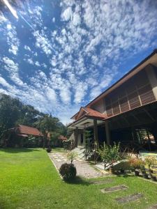 a building with a cloudy sky in a yard at Rivora Gopeng in Gopeng