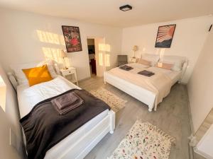 a bedroom with two beds and a rug at Mekcsey Udvar in Eger