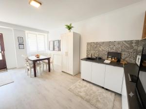 a kitchen with a table and a dining room at Mekcsey Udvar in Eger