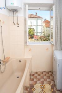 a bathroom with a tub and a window at Apartments Old Town in Budva +119 photos