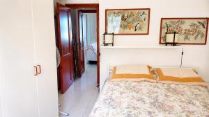 a bedroom with a bed and two pictures on the wall at La Tonnara House in Stintino +22 photos