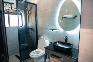 a bathroom with a sink and a toilet and a shower at Explorers Hub in Kampala +50 photos