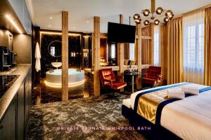 a hotel room with a bed and a bathroom at Life VOYAGE Résidence & Spa by Life Renaissance - Place KLEBER in Strasbourg