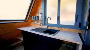 a kitchen with a sink in a tiny house at Cabin with jacuzzi and spectacular views in Oliva
