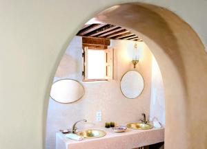 a bathroom with two sinks and two mirrors at Rooms in Dar Drouj, a special 14th century house Riad in Fez +119 photos