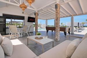 a living room with a pool table and a piano at Cape Serenity Mansion in Ayia Napa