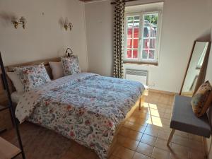 a bedroom with a bed and a window at 6 La Fiere in Sainte-Mère-Église