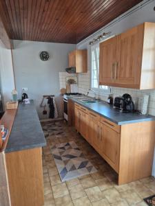 a kitchen with wooden cabinets and a blue counter top at 6 La Fiere in Sainte-Mère-Église