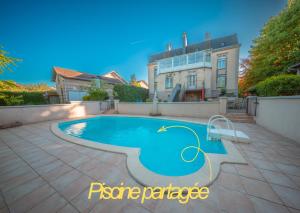 a swimming pool in the backyard of a house at La Source de la Scance in Verdun-sur-Meuse