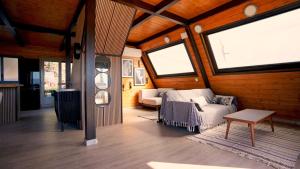 a living room with a couch and two windows at Cabin with jacuzzi and spectacular views in Oliva