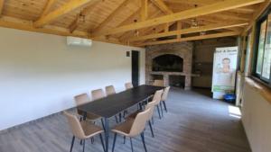 a conference room with a black table and chairs at Vlado Retreat in Banja Luka