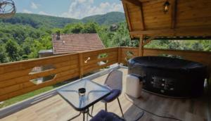 a patio with two chairs and a table on a deck at Vlado Retreat in Banja Luka