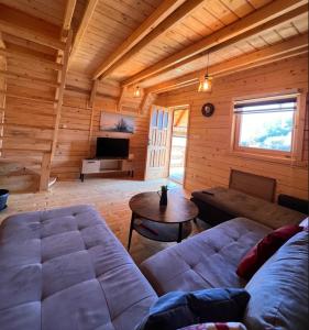 a living room with a couch and a table at Vlado Retreat in Banja Luka
