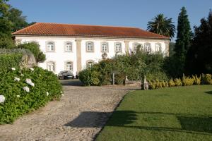 a large white house with a road in front of it at Casa do Condado de Beirós in São Pedro do Sul +31 photos