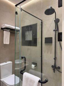 a bathroom with a glass shower with a toilet at IOS Village & Hotels in El Alamein +53 photos