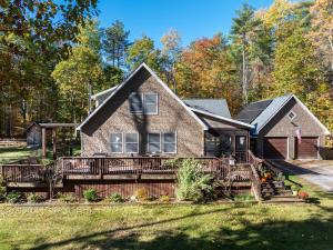 a house with a large deck in the yard at Luxury Retreat, Views, Near Whiteface, Lake Placid in Jay