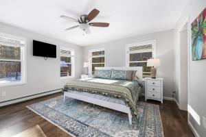 a bedroom with a bed and a ceiling fan at Luxury Retreat, Views, Near Whiteface, Lake Placid in Jay