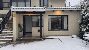 a house with a door in the snow at Ñireco HOUSE in San Carlos de Bariloche +48 photos