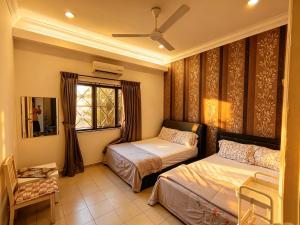 a bedroom with two beds and a window at MELAKA BEACH VILLA ( B TYPE ) in Malacca +54 photos