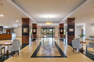 a lobby with chairs and a table and a bar at Suites Del Borgo in Olbia +112 photos