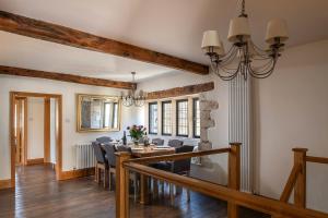 a dining room with a table and chairs at Serenity in Painswick