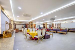 a dining room with a yellow table and chairs at Treebo Parth Paradise in Ghaziabad