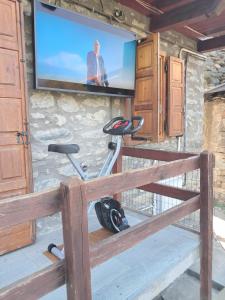 a room with a tv and a exercise bike at il Battito in Saint Vincent